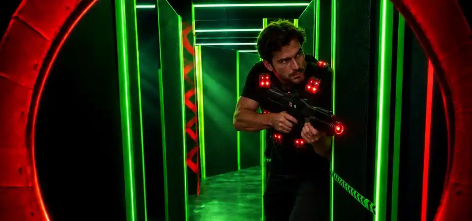 Illustrative action scene: a party group plays Lasertag among neon obstacles